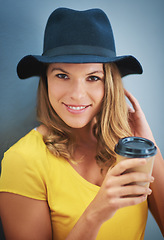 Image showing Portrait, coffee and fashion with a model woman in studio on a gray background for contemporary style. Face, hat and drink with an attractive young female hipster drinking a takeaway beverage