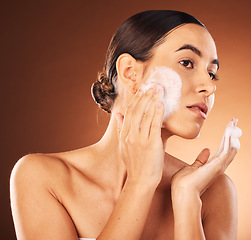 Image showing Woman, face wash and soap on studio background, healthy skincare and natural cosmetics, body wellness and luxury makeup. Young model, facial cleaning and foam, self care and aesthetic of beauty shine