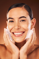 Image showing Hands with foam on face, beauty with woman and cosmetic product, cleaning and moisturizer with facial and happy in portrait. Skincare, clean skin and wellness with soap against studio background.