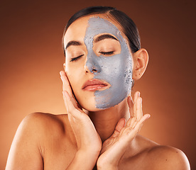 Image showing Skincare face, woman and mask for beauty, charcoal cosmetics cleaning and skin wellness treatment. Healthy face mask, natural facial dermatology and luxury spa makeup in orange studio background