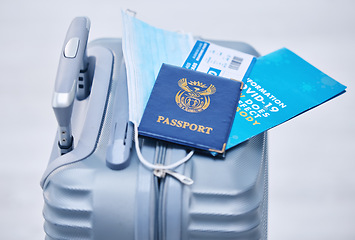 Image showing Covid, passport and suitcase for travel compliance, policy and documents in global, airport or visa information background. Corona, virus or covid 19 brochure with identity document, visa and luggage