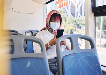 Image showing Travel, covid and phone with muslim woman on bus by window for safety, technology and public transport. Health, internet and social media with girl typing on mobile for communication, global or virus