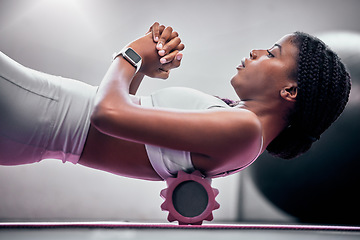 Image showing Yoga, floor and black woman with foam roller for massage, healthcare or back support help in health club, studio or gym. Muscle relief, sports wellness and neon pilates athlete doing fascia exercise