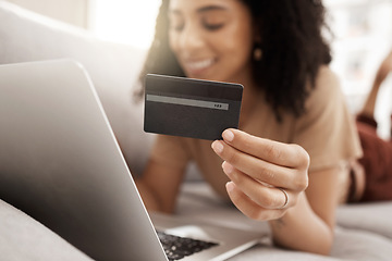 Image showing Hand, credit card and online shopping with a black woman customer using her laptop in the living room. Finance, computer and accounting with a female consumer spending money through ecommerce