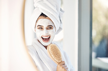 Image showing Woman, face mask and mirror with a brush for singing, beauty and home spa treatment in bathroom with a towel and bathrobe. Face of happy female doing facial for self care and detox with cosmetics