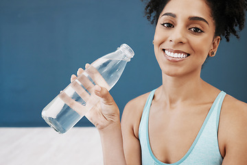 Image showing Drinking water, fitness and black woman in workout studio with blue wall mockup for healthy lifestyle, wellness and nutrition. Portrait of sports, athlete or yoga woman with water bottle for exercise