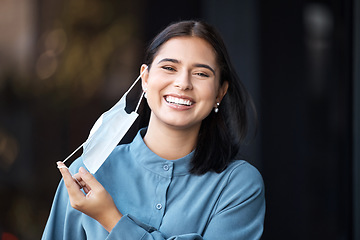 Image showing Covid, freedom and finished with a woman mask removal with a smile outdoor in the fresh air. Health, safety and portrait with a female excited to stop or complete corona virus epidemic regulations