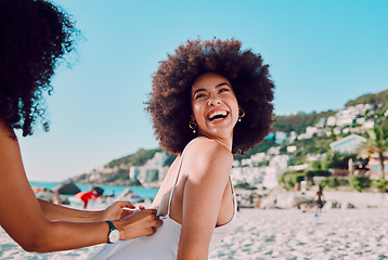 Image showing Sunscreen, black woman and friends at a beach for a happy vacation or holiday to relax with freedom in Miami. Smile, travel and women helping a young gen z girl with skincare cream on back at sea