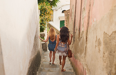 Image showing Friends, summer and travel on city alley steps in Brazil for holiday, walk and adventure. Youth, freedom and girl tourists walking on village stairs together for vacation exploration.