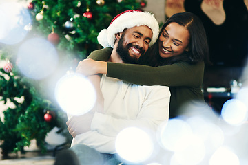 Image showing Black couple, Christmas celebration and hug with love, enjoy the festive season and relax in living room of apartment home. Happy man, black woman hugging and celebrate xmas December holiday together