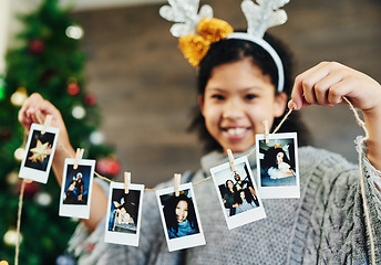 Image showing Girl portrait, polaroid and christmas celebration, happy smile and memories, photograph and decoration in home. Child, picture and string for xmas, celebrate and festive holiday, happiness and kid