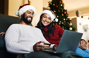 Image showing Credit card, Christmas and black couple on laptop and sofa for home online shopping, easy e commerce payment and banking. Happy people on couch in living room with website sale on holiday finance app