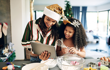 Image showing Mother, child and tablet for christmas baking, cooking and holiday celebration for cookies or cake with family home wifi for app. Woman and girl or daughter learning food recipe together in kitchen