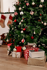 Image showing Christmas, tree and gift on the floor of a home living room in celebration or preparation for the festive season. Morning, present and tradition with a Christmas tree in a house for xmas holidays