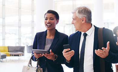 Image showing Business black woman and man talking, walking and in office for planning together. Coworkers, female manager and male employee have conversation, tablet and smartphone for discussion and strategy.