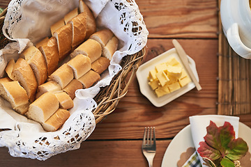 Image showing Buffet table, flatlay of bakery bread with butter in buffet and kitchen counter with wood texture background. Restaurant with brunch food, healthy meal for dinner and plate of lunch with cutlery