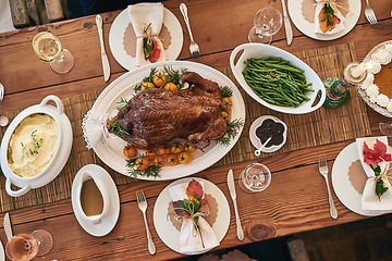 Image showing Christmas lunch, top view and food on wood table of dining room for healthy meal, festive celebration and holiday event. Formal meal, roasted chicken and healthy thanksgiving dinner party at home