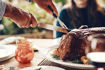 Image showing Turkey, thanksgiving and chicken cut by hands at a table for a family at a home or house gathering celebration. Party, zoom and man with knife cutting food or meat to celebrate and eat with friends