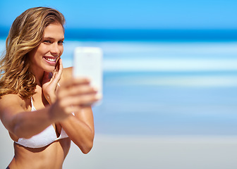 Image showing Influencer, phone and woman taking a selfie at a beach for a social media audience or travel blog online in Sao Paulo, Brazil. Model, content creator or happy girl taking pictures in summer in bikini