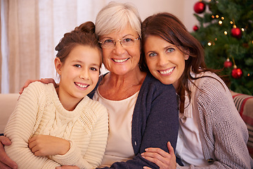 Image showing Portrait of grandmother, mother and girl at Christmas on sofa bonding, loving and enjoying holiday season together. Family, love and child with grandma and mom on festive, celebration and vacation
