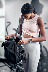 Image showing Black woman, water bottle or fitness bag in gym workout break, cardio training or heart health exercise for strong body muscles. Happy smile, personal trainer or sports athlete coach and energy drink