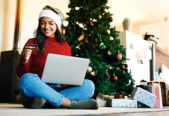 Image showing Woman, laptop and online shopping for christmas with credit card in living room. Ecommerce payment, online retail customer and xmas shopping gifts on computer website to celebrate holiday vacation