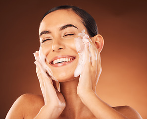 Image showing Skincare, hands and foam on face for cleaning with smile, happiness and spa wellness. Facial wash, luxury cosmetics therapy and self care with soap for beauty, dermatology grooming and cosmetology