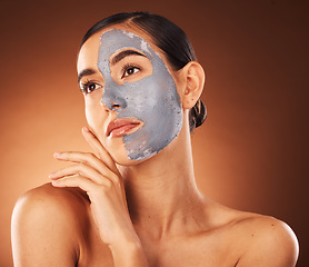 Image showing Woman, clay face mask and beauty, facial makeup and detox dermatology on studio background. Female model, skincare product and charcoal cosmetics for shine, natural glow and aesthetic transformation