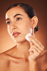 Image showing Woman, skincare beauty and cotton for face, health and cleaning for cosmetic glow by brown studio backdrop. Model, cottonwool and skin with moisturiser, wellness and natural cosmetics by backdrop
