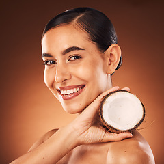 Image showing Coconut, woman and beauty, skincare and portrait, cosmetics and healthy food for diet, aesthetics and body nutrition benefits on studio background. Happy young model, coconut oil and natural wellness