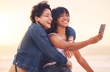 Image showing Beach, summer and friends taking selfie with phone enjoying holiday, vacation and weekend together. Freedom, travel and women happy, relax and bonding to take photo with smartphone for social media