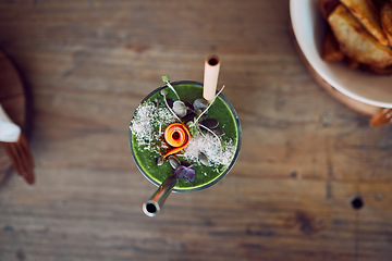 Image showing Top view, fruit smoothie or green juice as healthy breakfast diet, weight loss or protein milkshake in home kitchen, house or restaurant. Morning wellness cup, detox drink or vegetable leaf cocktail