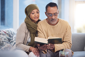 Image showing Reading, book and eid mubarak with a muslim couple in the living room of their home together with the quran. God, Islam and ramadan with a man and woman bonding over religion in their house