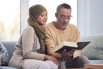 Image showing Muslim couple, reading Quran and spiritual with islam, hijab and book for faith, trust and learning scripture in home. Islamic man, woman and read religious book, support and learn on eid Mubarak