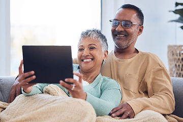 Image showing Love, senior couple and tablet on sofa, social media or online reading together in lounge. Mature man, elderly woman or device to search internet, bonding or loving for video call, happiness or relax