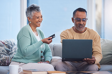 Image showing Couple, laptop and credit card for ecommerce, online shopping or transaction together at home. Elderly man and woman with smile for easy internet banking on computer relaxing on living room sofa