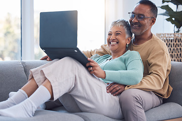 Image showing Mature couple, laptop and relax on sofa in living room, house and home on streaming subscription, online shopping and download internet media show. Happy man, woman and computer technology in lounge