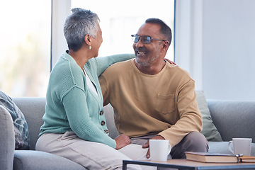 Image showing Elderly couple, smile and hug laughing on sofa or relaxing and bonding time together at home. Happy man and woman relax and enjoying social conversation in love on living room couch at the house