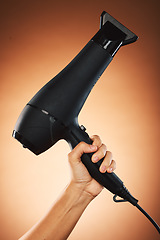 Image showing Hair, hand with hair dryer and hair care with beauty and cosmetic advertising against orange studio background. Salon, hairdressing and hairstyle tool or appliance with cosmetics marketing.