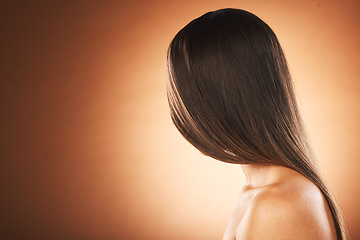 Image showing Hair care, shine and woman marketing a salon, hairdresser mockup and space on a brown studio background. Brunette, luxury advertising and model with straight hair from hair salon with mock up