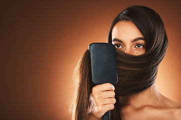 Image showing Hair care, salon and woman brushing hair, beauty glow and mockup space against brown studio background. Luxury shine, clean and model with a brush for hairdresser styling and advertising with mock up