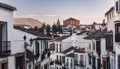 Image showing Views of the medieval village of Ronda with white Andalusian houses and the gothic style church of Santuario de Maria Auxiliadora. Malaga, Spain.