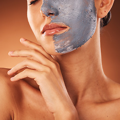 Image showing Woman, face mask or skincare mud facial on orange studio background in self care, dermatology or acne treatment. Zoom, beauty model or cream product for cleaning, healthcare glow or collagen wellness