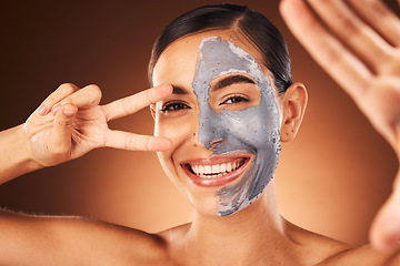 Image showing Beauty, portrait and woman taking selfie with face mask and peace sign hand gesture in studio for skincare. Smile, peeling and happy girl model taking pictures in facial dermatology cosmetics cream