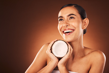 Image showing Coconut, skincare and beauty woman in studio for natural product advertising or marketing mockup. Idea, thinking or excited face model with fruit dermatology, cosmetics or nutrition benefit promotion