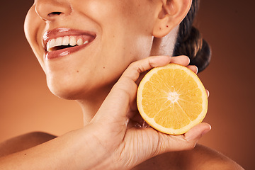 Image showing Face, teeth and skincare of woman with lemon in studio isolated on a brown background. Beauty, wellness and smile of happy female model with citrus fruit for healthy vitamin c, nutrition and minerals