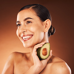 Image showing Beauty, wellness and woman in studio with avocado for diet, healthy eating and skin health on brown background. Skincare, girl and model with fruit, nature and product for cleaning, facial and mask