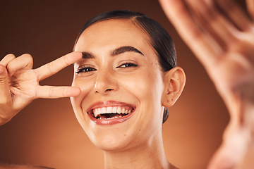 Image showing Happy, selfie and woman with peace sign, smile on face and studio background for marketing or advertising. Beauty, skincare and happy woman taking self portrait, excited celebration healthy lifestyle