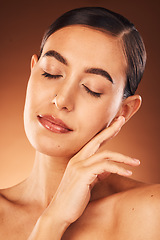 Image showing Skincare, facial and hands of woman on face in studio for beauty, makeup and hygiene wellness on orange background. Hand, girl and model in India for cosmetic, product and smooth skin care mock up