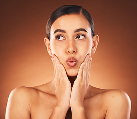 Image showing Beauty, skincare and woman in a studio with a natural, health and wellness face treatment. Self care, pout and female model from Mexico with facial skin routine isolated by gradient brown background.